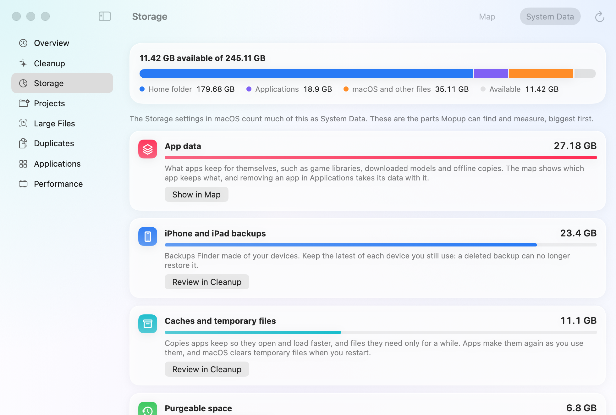 Mopup's System Data breakdown on a demo Mac: app data at 27.18 GB, iPhone and iPad backups at 23.4 GB, and caches and temporary files at 11.1 GB, each explained, with a button to see it in the map or review it in Cleanup.